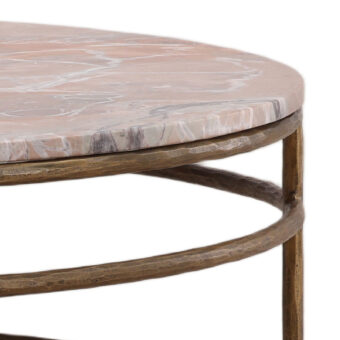 Coffee table by Dovetail with mottled pink marble stone surface, white and grey veining, and antique bronze metal base