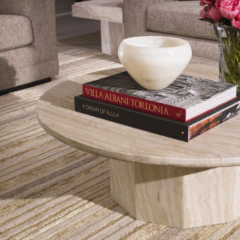 Coffee table by Eichholtz Florence in beige cream travertine with honed finish, faceted hexagonal base, organic grain