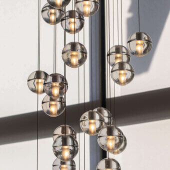 Elegant Bocci 14 Random Suspension lamp with articulated cast glass spheres in neutral gray and frosted cylindrical voids