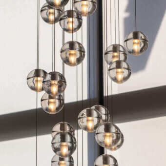 Elegant Bocci 14 Random Suspension lamp with articulated cast glass spheres in neutral gray and frosted cylindrical voids