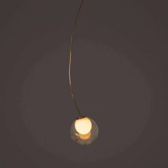 Distinguished Bocci 28 single suspension lamp with gracefully curved form in clear glass and natural copper exhibiting evolving patina