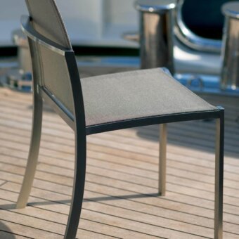 Elegant Royal Botania O-Zon chair with brushed stainless steel frame and woven gray Batyline seat presents a balanced design
