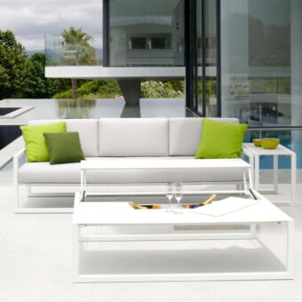 Elegant Royal Botania Ninix lounge sofa with stainless steel frame and light grey Batyline seat complemented by vibrant green fabric cushions