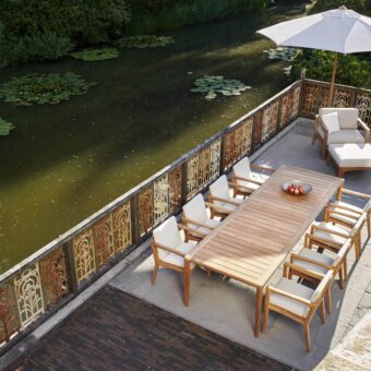 Exquisite Royal Botania U-nite table with slatted teak top and base exhibiting a light brown hue and natural wood grain