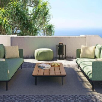 Distinguished Royal Botania Styletto lounge coffee table with sustainable teak wood top and dark metal border finish
