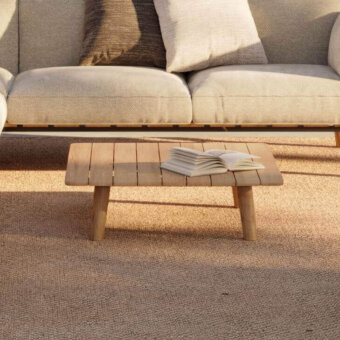 Luxury Royal Botania Mambo Lounge coffee table in teak wood, designed with a slatted tabletop supported by cylindrical legs, showcasing a natural finish.