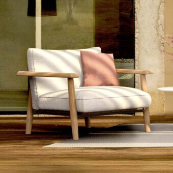 Comfortable Royal Botania Mambo Lounge chair in light textile with natural wooden frame, designed for relaxation.