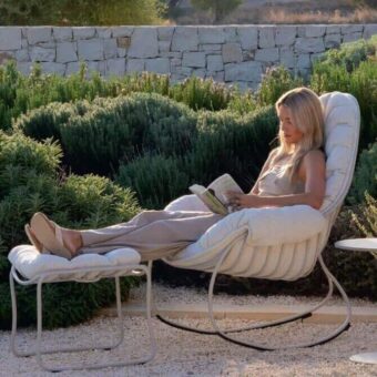 Royal Botania folia rocking lounge chair, beige fabric upholstery, light gray metal frame, with matching ottoman and side table.