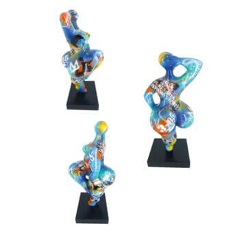Juliarte "baila" sculptures, translucent resin, dynamic poses with vibrant pop art collage of logos, text, and abstract patterns on black bases.