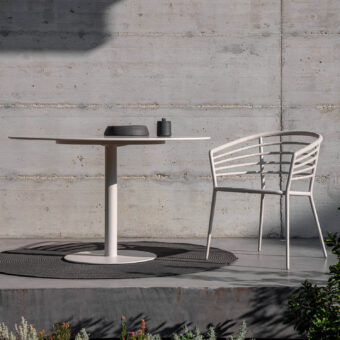 Sophisticated Royal Botania Archy armchair crafted with textured pale synthetic material and integrated sleeves wrapping a tubular backrest
