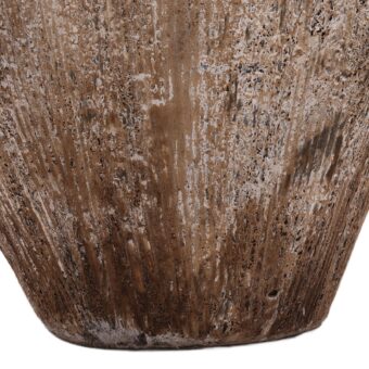 Planter by Dovetail in porous stone, styled with a weathered finish, rounded silhouette, brown tones, and highlights