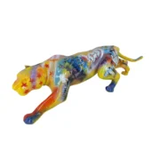 Panther sculpture, resin, graffiti style; yellow head, orange legs, with blue, red, black & white abstract collage details on a gray surface.
