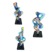 Juliarte "baila" sculptures, translucent resin, dynamic poses with vibrant pop art collage of logos, text, and abstract patterns on black bases.