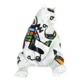 Seated bear sculpture, white ceramic, abstract Miro-style painting in black, red, yellow, blue, and green with geometric and organic shapes.