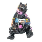 Black bear sculpture with glossy graffiti design, featuring pink, yellow, orange, purple, and white star patterns, Juliarte style.