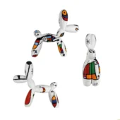 Balloon dog sculptures by Juliarte, white ceramic with geometric patterns in red, yellow, blue, green, and black, twisted form.
