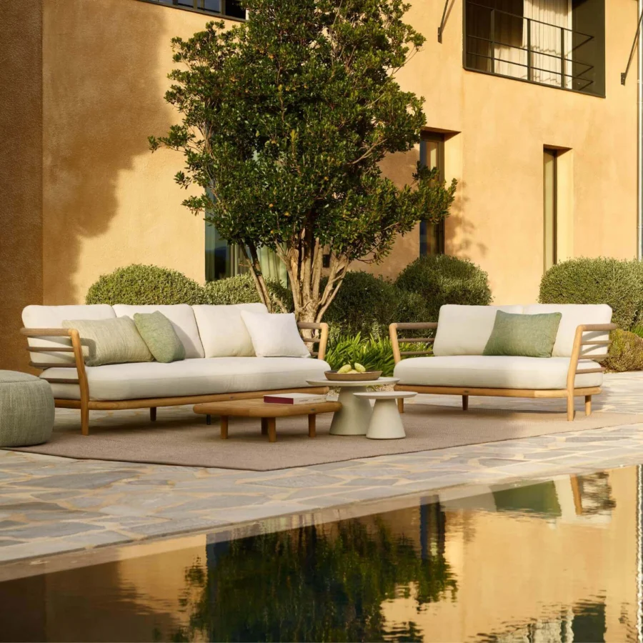 Sofa by Royal Botania Archy in teak wood with natural finish, light beige upholstery, slat backrest and tapered legs