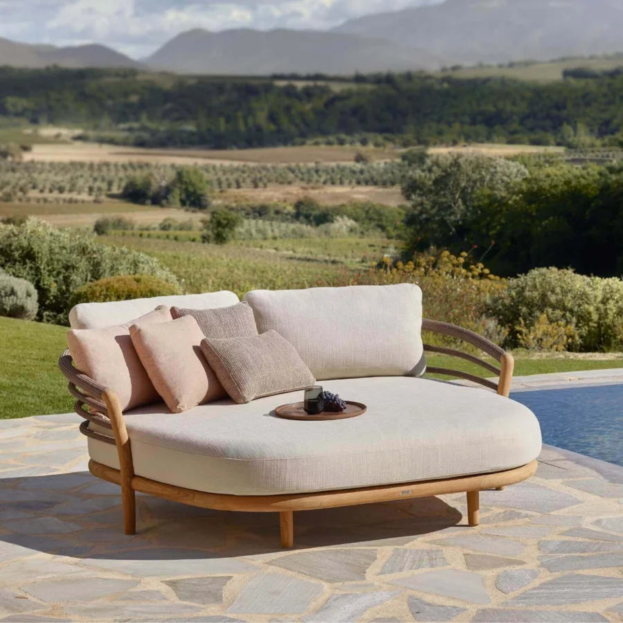 Daybed by Royal Botania Archy in teak wood with smooth finish, woven rope, light beige upholstery and multi-toned pillows