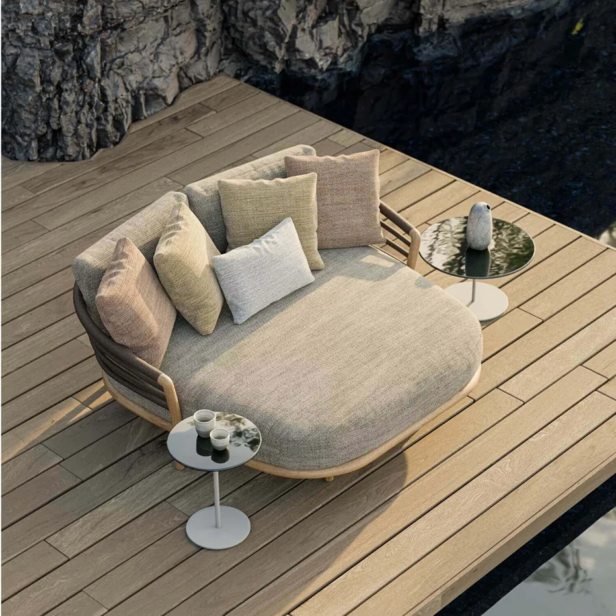 Daybed by Royal Botania Archy in solid teak wood with light finish, beige cushion, dark rope backrest and colored toss…