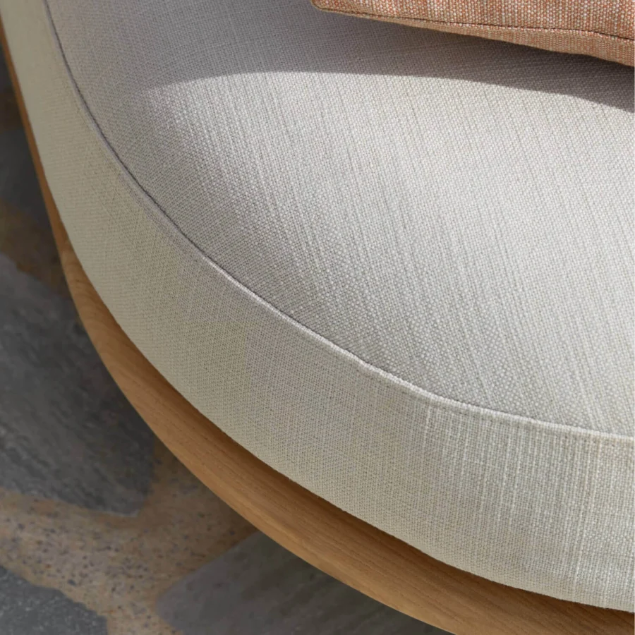 Daybed by Royal Botania featuring solid teak wood in natural matte finish paired with light beige upholstered seat cushion