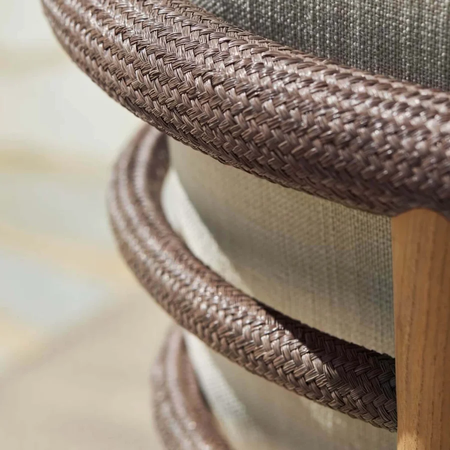 Day-bed by Royal Botania with solid teak wood frame, medium brown woven cording backrest and grayish-beige upholstery