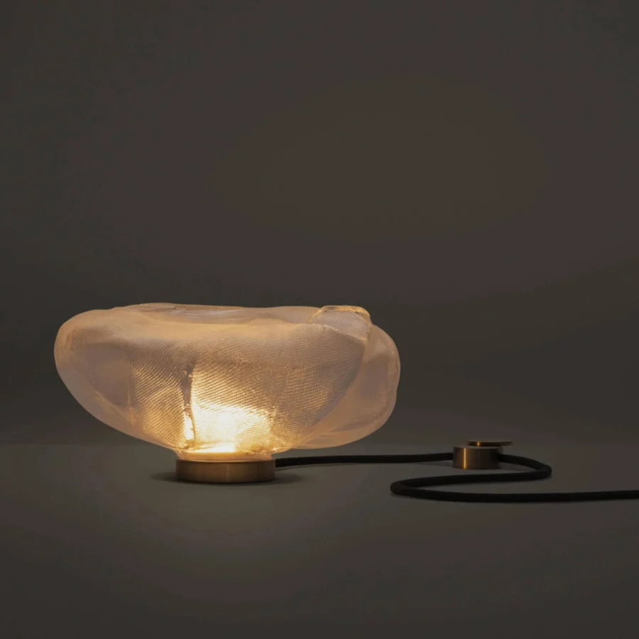 Table lamp by Bocci featuring glass diffuser with metallic mesh finish, resting upon gold tone metal base and black cord