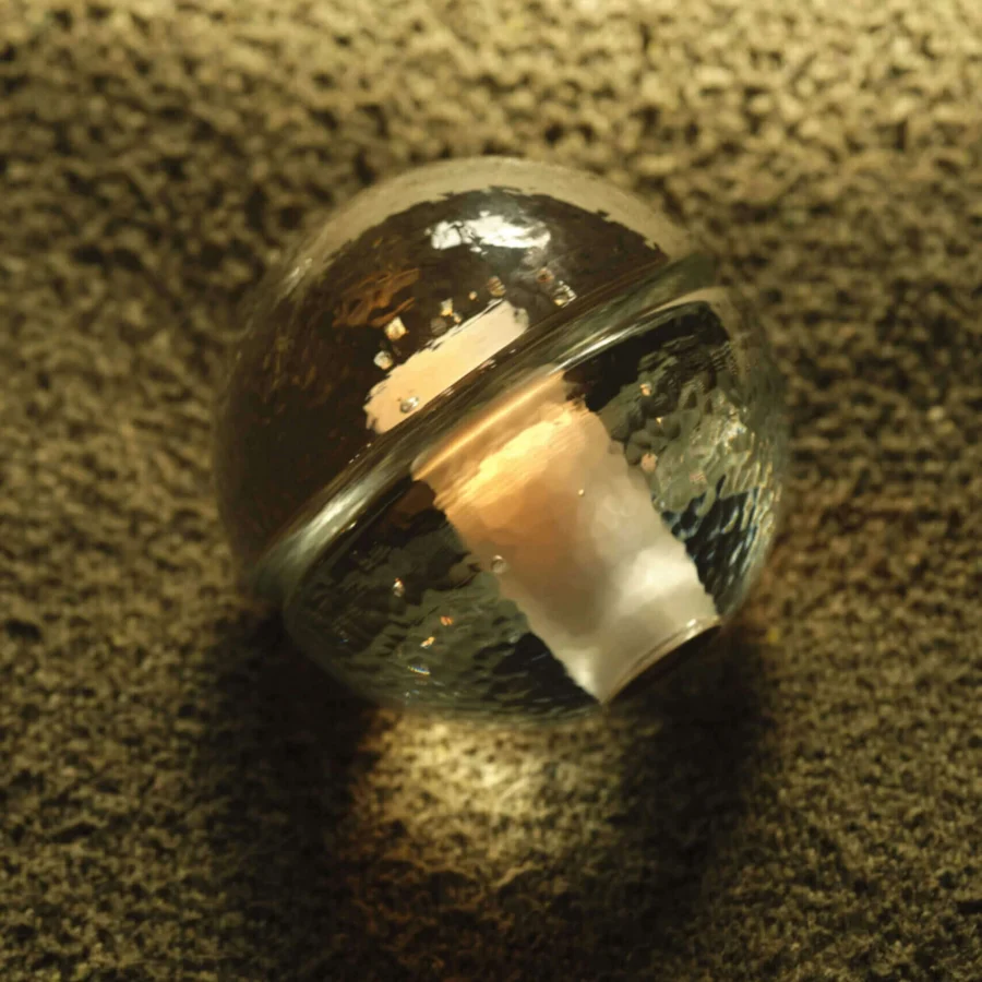 Table lamps by Bocci with spherical glass body and frosted interior cavity in transparent or warm amber white glossy finish