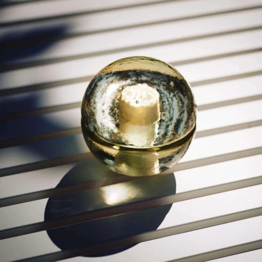 Lamp by Bocci in spherical glass with golden tones and glossy reflective finish, sold as a set of four cordless…
