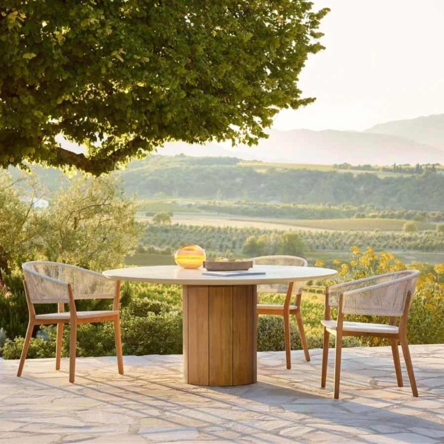 Table by Royal Botania Regaliz with smooth off-white stone top and central cylindrical base crafted from natural wood slats