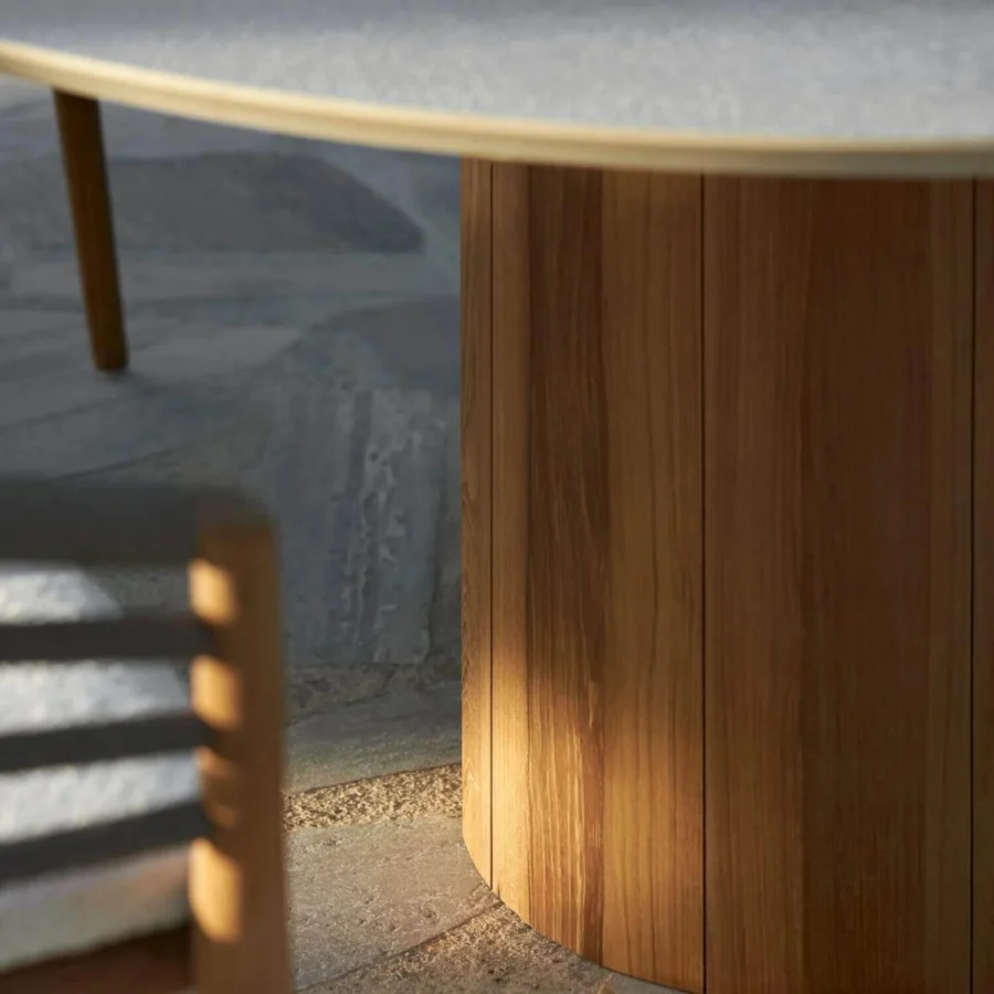 Table by Royal Botania Regaliz with light gray textured top, cylindrical base in medium brown wood finish and slat panels