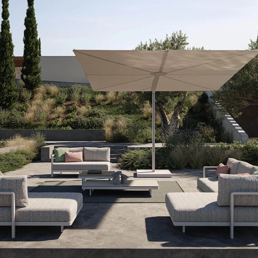 Distinguished Royal Botania Solaz umbrella with a light beige textile canopy and smooth silver metal frame built for full tilt and rotation