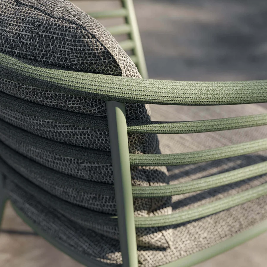 Elegant Royal Botania Archy armchair with a gracefully curved matte Sage metal frame and muted gray woven Batyline seat