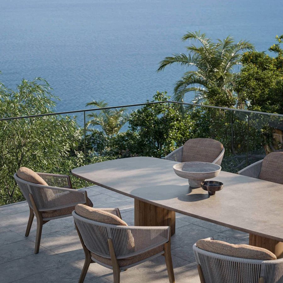 Sophisticated Royal Botania Regaliz table with light gray glass and warm-toned teak bases presenting a textured finish