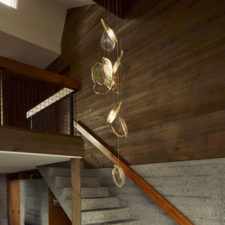 Captivating Bocci 141 Random suspension lamp with warm amber glass pendants and dark-toned metal canopy crafted in textured glass