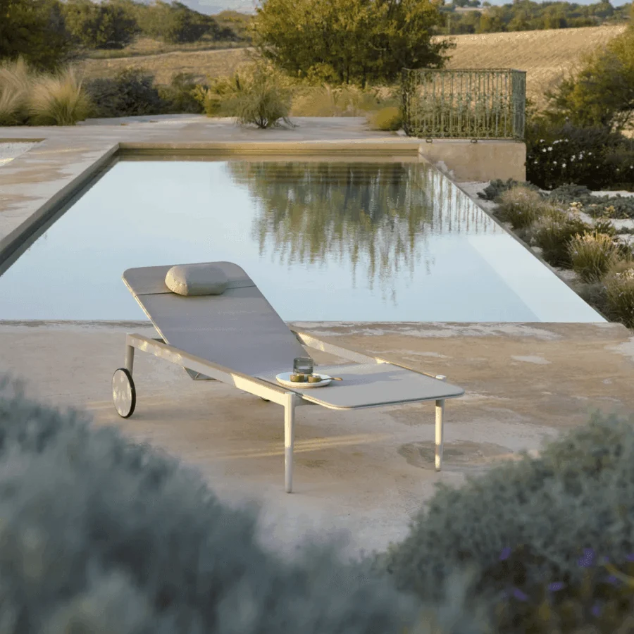 Superior Royal Botania Styletto lounger with light gray textile seating and powder-coated metal frame built with integrated wheels