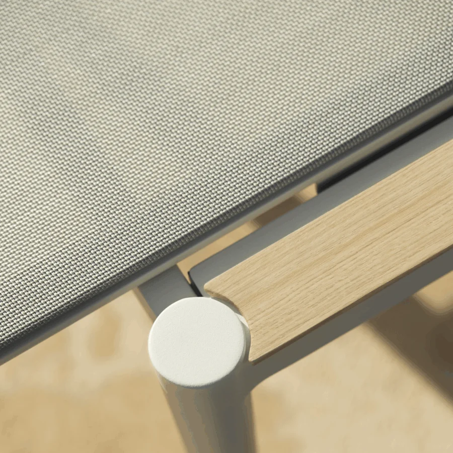 Distinguished Royal Botania Styletto lounger with light gray woven textile, light-colored wood, and matte off-white metal frame