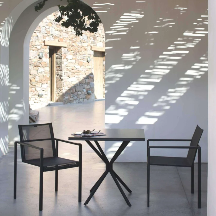 Captivating Royal Botania Alura armchair crafted with black textured aluminum and integrated armrests for contemporary spaces