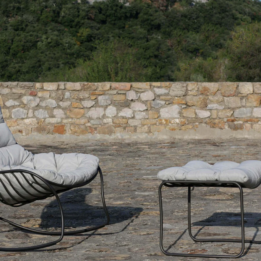 Elegant Royal Botania Folia Rocking Lounge Chair with light gray tufted textile cushions and dark powder-coated metal frame including ottoman