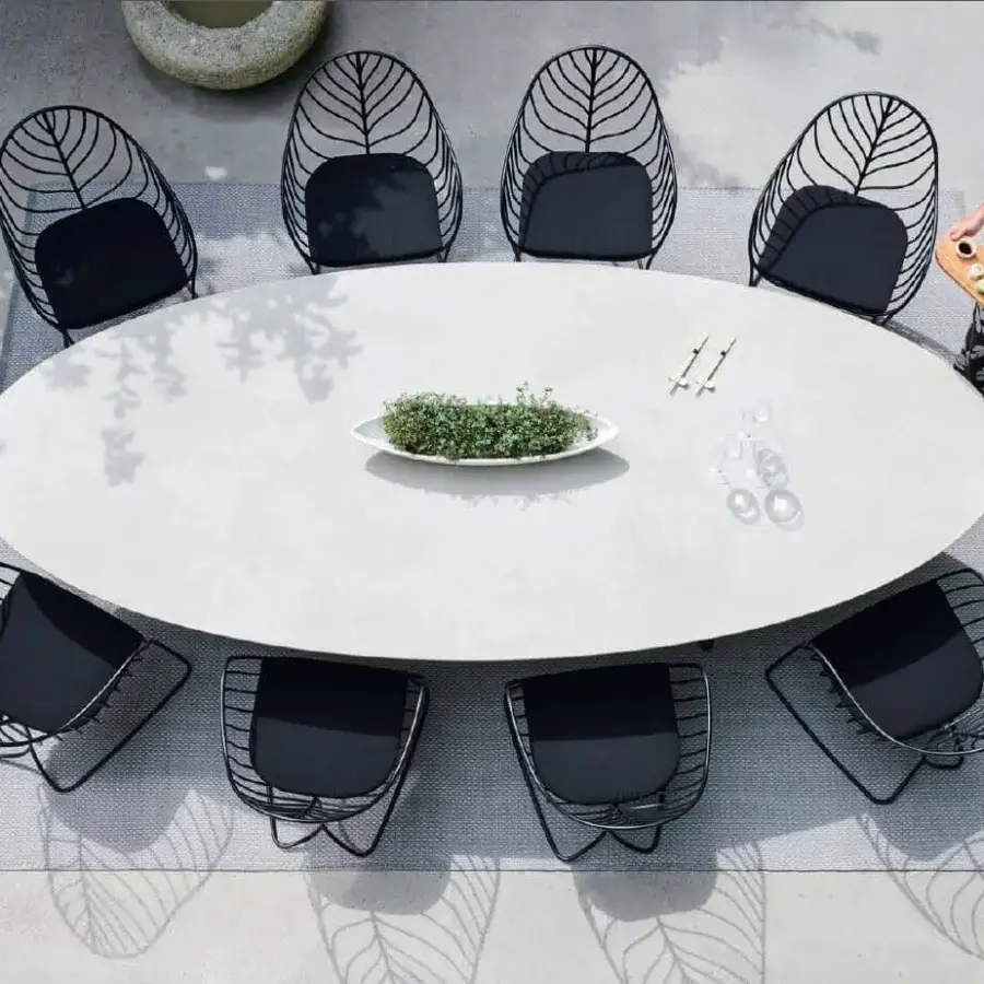Captivating Royal Botania Folia armchair with a matte black metal frame and uniformly dark cushion embodies modern minimalist design