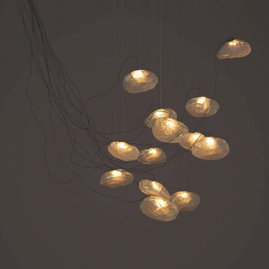Captivating Bocci 73 sculptural cable suspension lamp with pale amber blown glass and dark braided metal coaxial cable