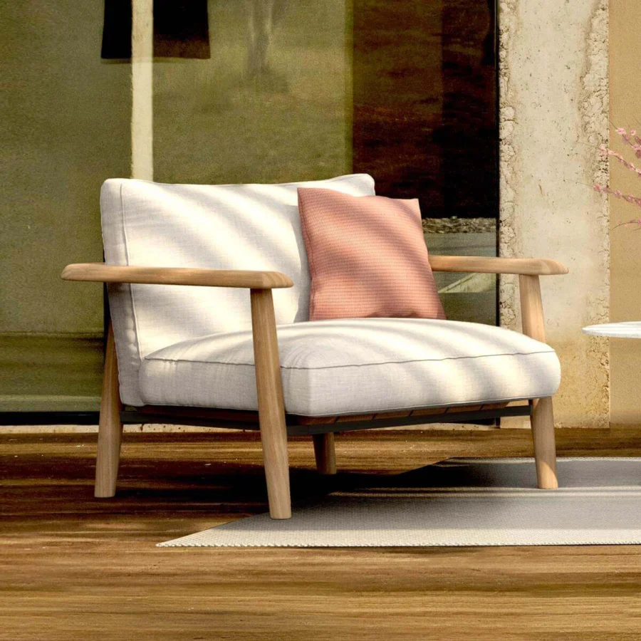 Comfortable Royal Botania Mambo Lounge chair in light textile with natural wooden frame, designed for relaxation.