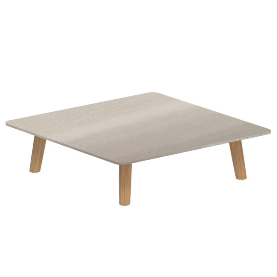 Luxury Royal Botania Mambo Lounge coffee table in rectangular shape with a light beige, textured tabletop and natural wood legs