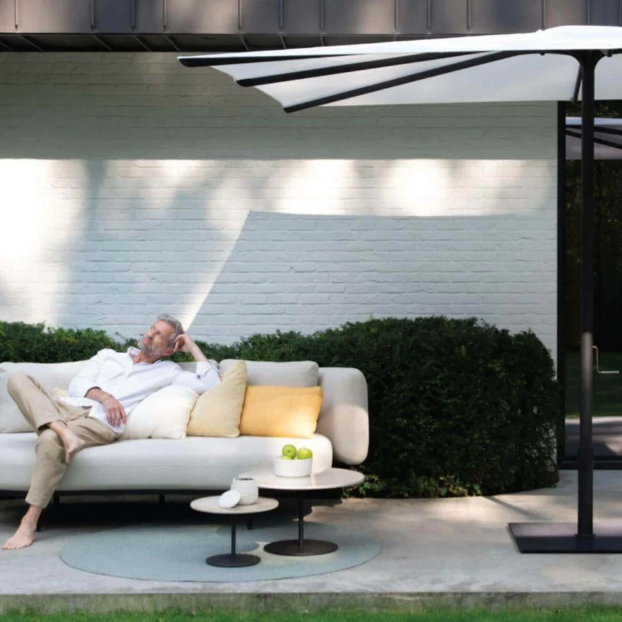 Elegant Royal Botania Bloom sofa with smooth lines, neutral textile, and cream yellow cushions in matte finish