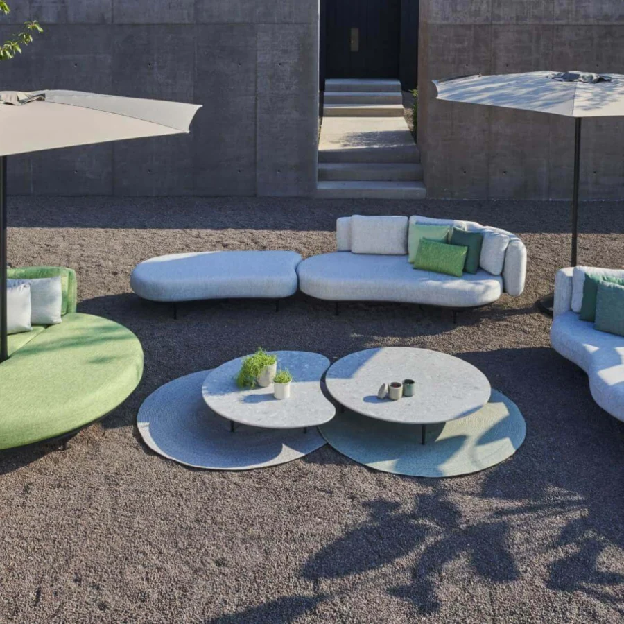 Innovative Royal Botania Palma umbrella table with organically shaped ribs and matte light gray and muted green composite finish