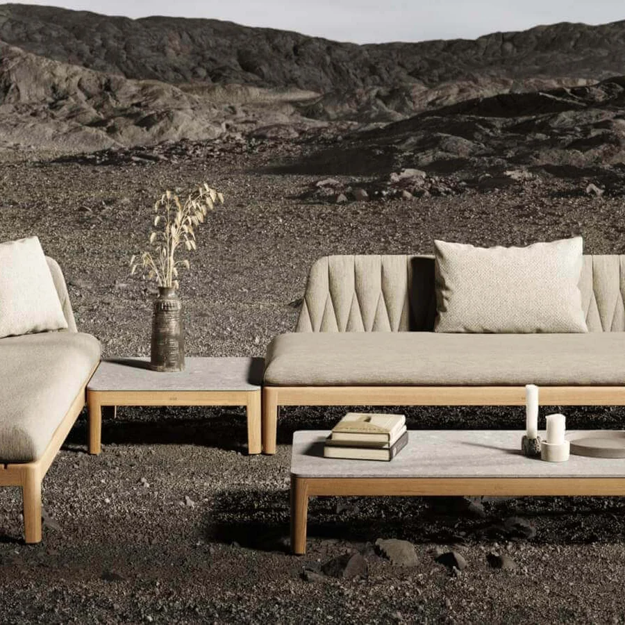 Distinguished Royal Botania Calypso sectional with teak base and stainless steel U-shaped backrests, complemented by sumptuously comfortable taupe textile cushions
