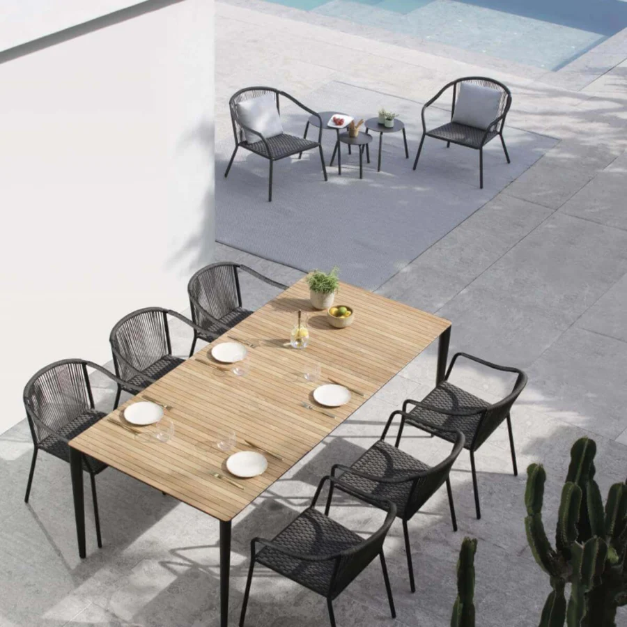 Elegant Royal Botania U-nite table crafted with light teak and dark metal exhibiting a smooth matte finish