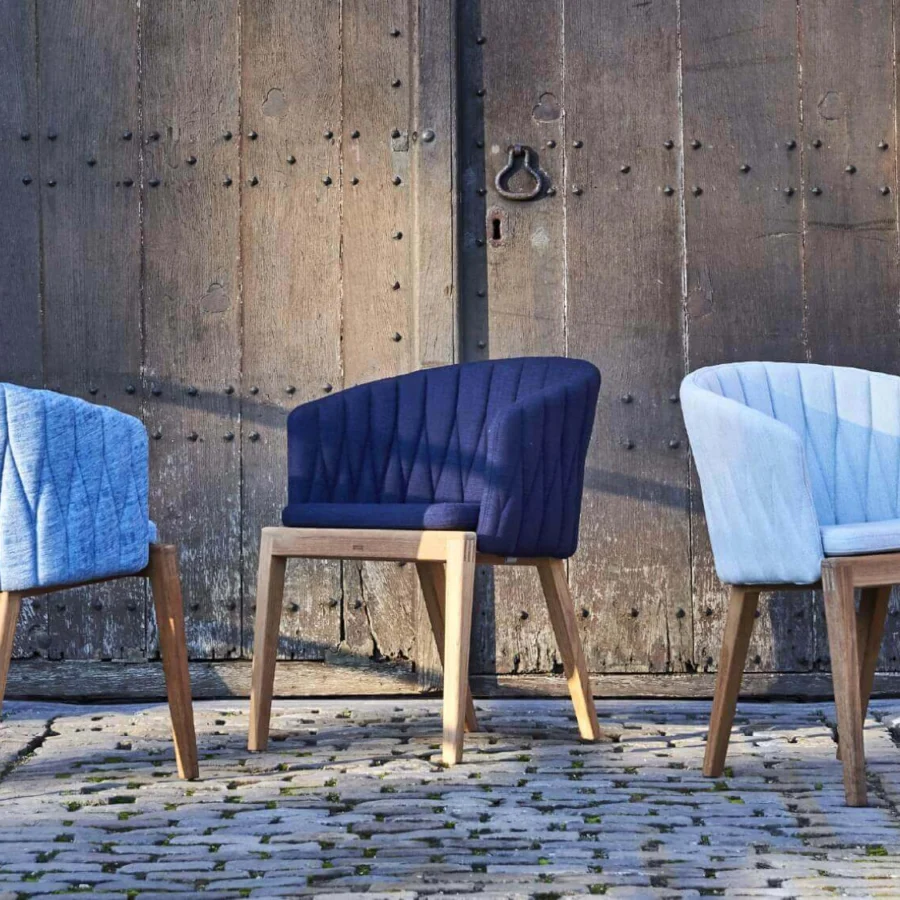 Exceptional Royal Botania Calypso armchair with light blue quilted textile upholstery and smooth teak with stainless steel base