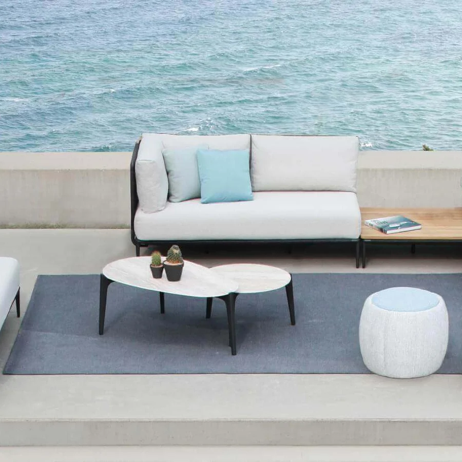 Exclusive Royal Botania Tono ottoman with molded plastic core and light blue zippered textile exhibiting a textured finish