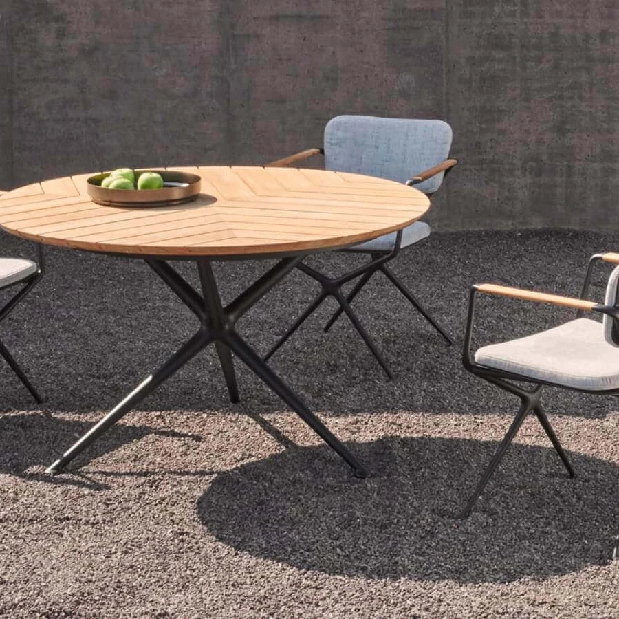 Distinguished Royal Botania Exes table with teak wood tabletop and coated aluminum star-like base showcasing a smooth radial finish