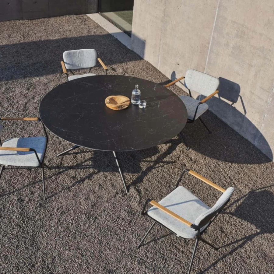 Superior Royal Botania Exes table with dark marble-like ceramic top and intersecting coated aluminum legs in matte finish